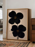 Minimalist flower print shown with warm wood and gold frame accents