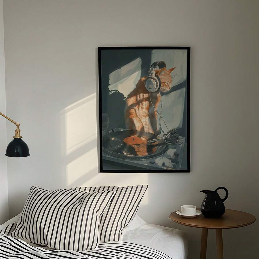 Black framed DJ cat poster above bed