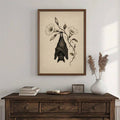 Vintage bat botanical canvas above dark wood dresser with books and vase