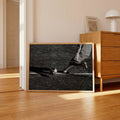 Football kick canvas poster beside wood dresser