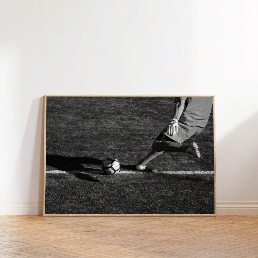 Soccer player kicking ball poster on wood floor