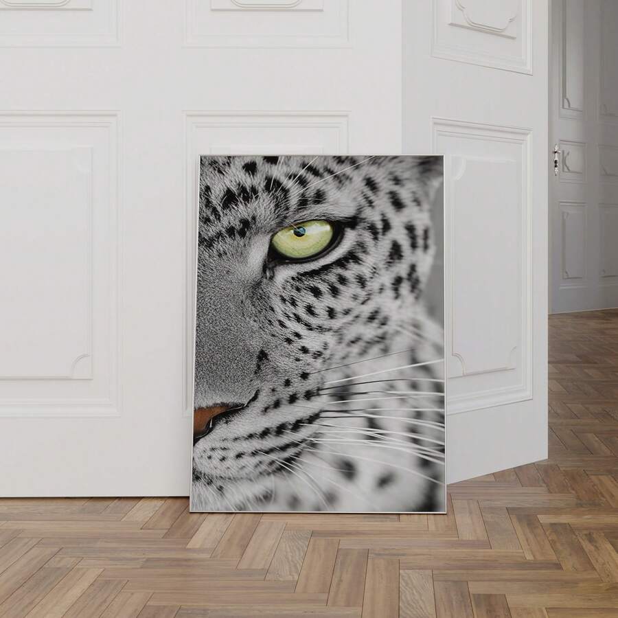 Black and white leopard eye poster beside chair