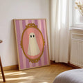 Soft gothic ghost wall art displayed beside a neutral bedroom