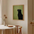 Minimalist black cat print with yellow eye and green background