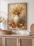 Framed autumn still life poster with ceramic pitcher and maple leaves above woven cabinet