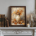 Dark wood framed autumn still life poster on mantel with books candles and glass vase nearby