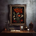 Long Live Halloween graveyard poster in antique frame above dark academia desk