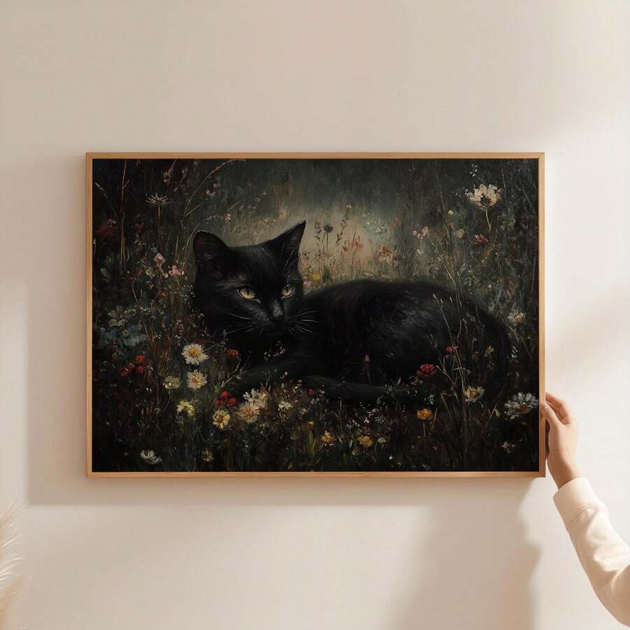 Minimal wall display of dark pastoral black cat wildflower poster held by hand against pale wall