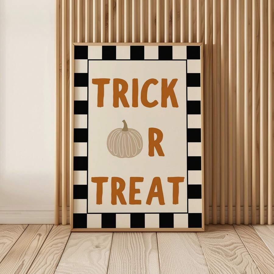Framed Trick Or Treat Halloween poster leaning on light wood floor with orange text pumpkin icon and black cream checker border