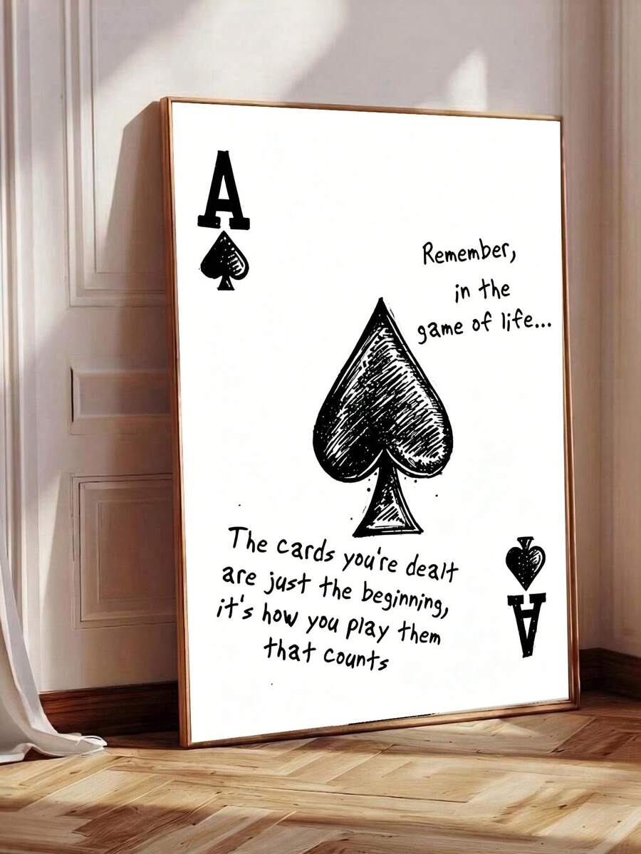 Large framed ace of spades motivational poster leaning on wood floor with black hand drawn spade and life quote
