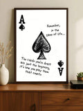 Framed ace of spades motivational poster on wood cabinet with black hand drawn spade and game of life quote