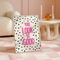 Playful pink wall art displayed with a green table lamp