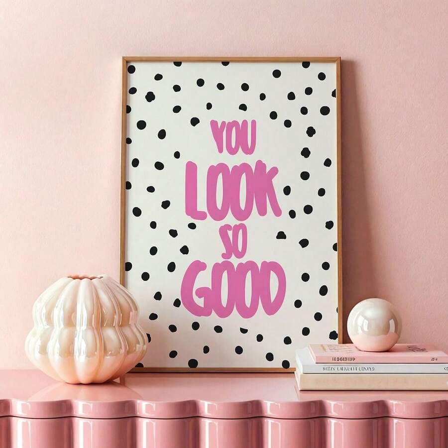 Polka dot quote artwork on a pink and white interior surface