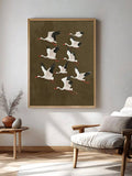 Vintage stork wall art displayed above a mid century lounge chair