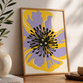 Retro floral print leaning on a wooden console beside a ceramic vase and leafy branch