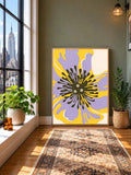 Oversized floral wall art leaning beside a city window with a woven rug and potted plants