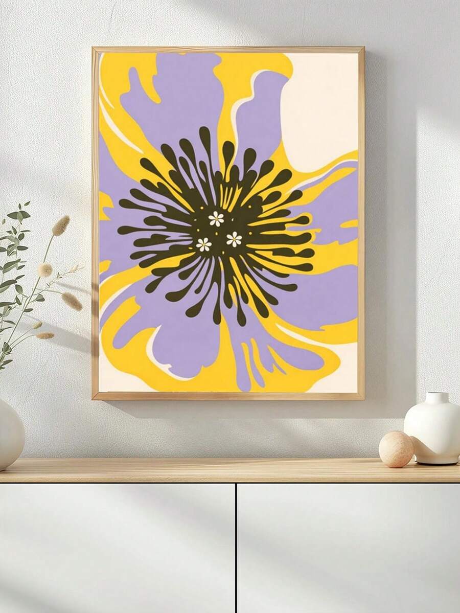 Purple and yellow abstract flower wall art in a natural wood-look frame above a white cabinet