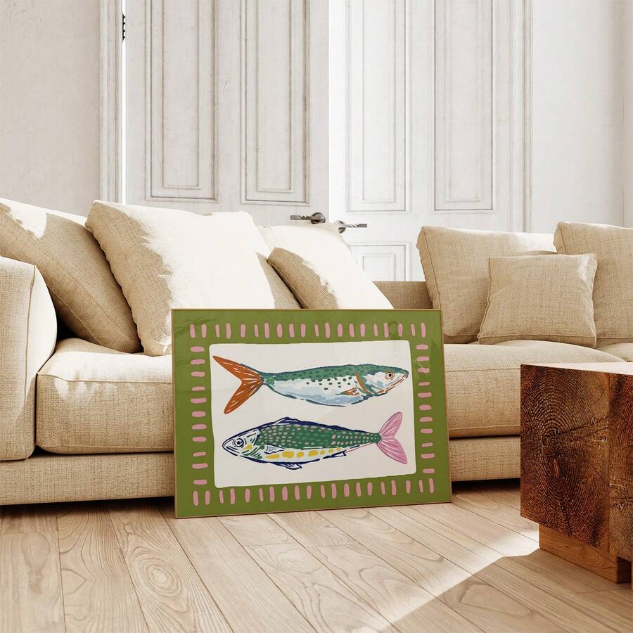 Colorful fish poster with olive border displayed against cream living room sofa