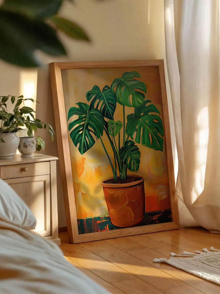 Large orange monstera poster leaning in a bright bedroom beside houseplants