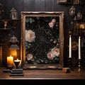 Ornate framed rose and spiderweb print in a candlelit Victorian gothic room