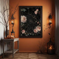 Dark framed rose and spiderweb wall art in an orange Halloween room
