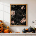Gold framed floral spiderweb print displayed above orange and black pumpkins