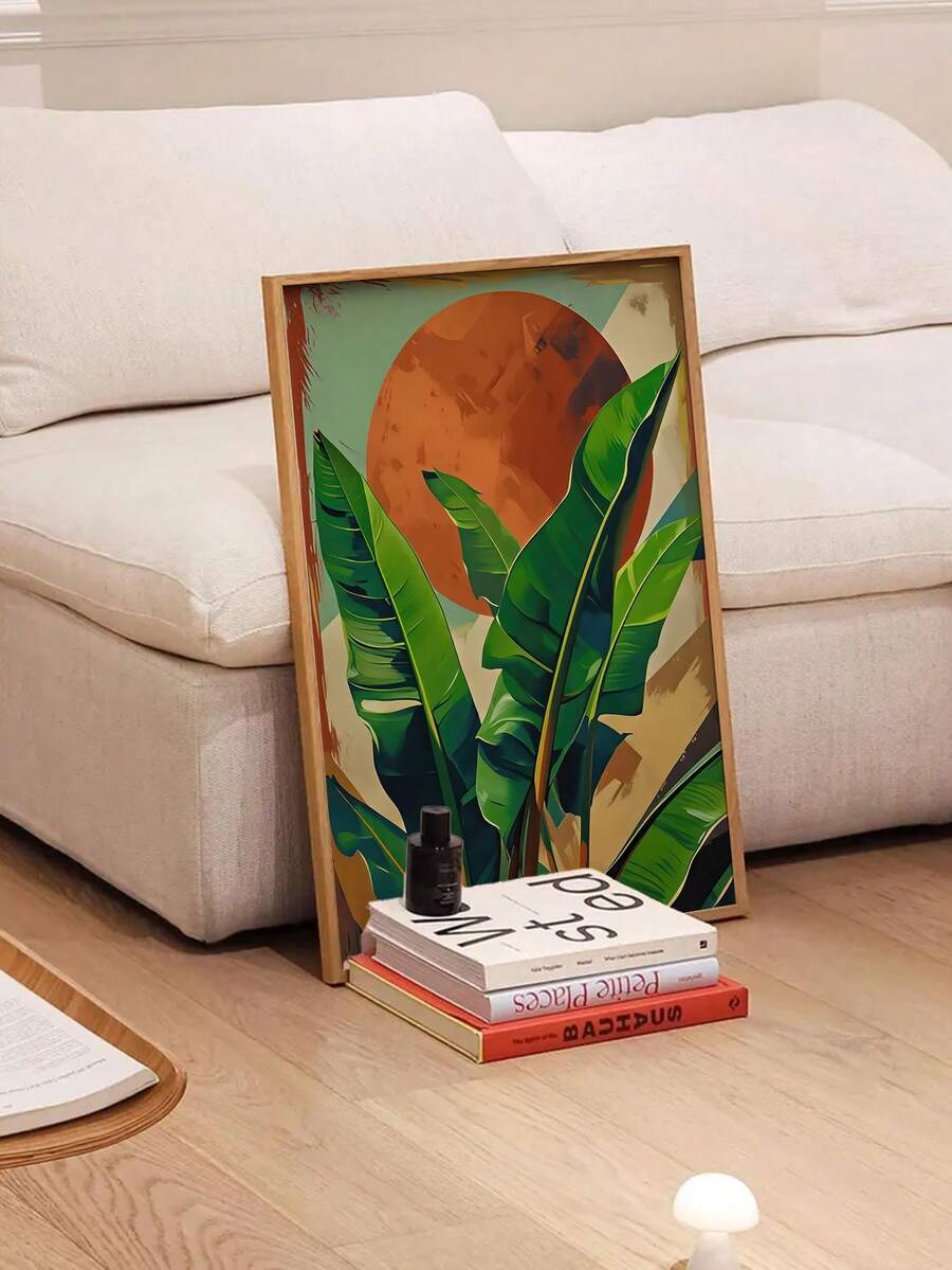 Framed orange and green botanical art displayed beside a cream sofa