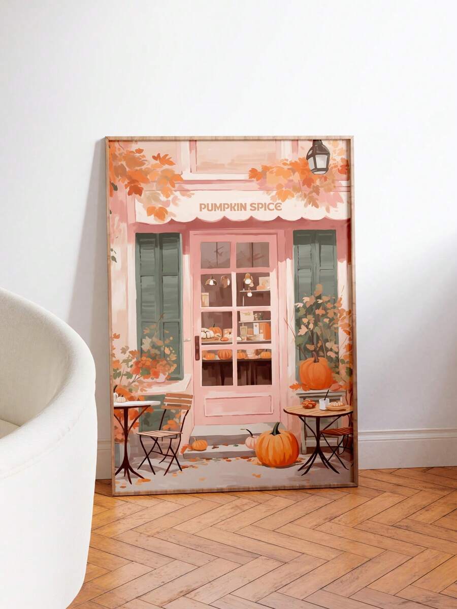 Large framed pumpkin spice cafe print leaning on wall with pumpkins pink storefront and autumn leaves