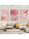 Large 3-piece blush pink abstract canvas set with gold veining above sectional sofa