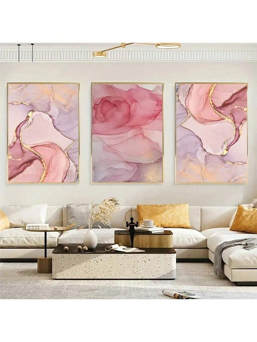 Large 3-piece blush pink abstract canvas set with gold veining above sectional sofa