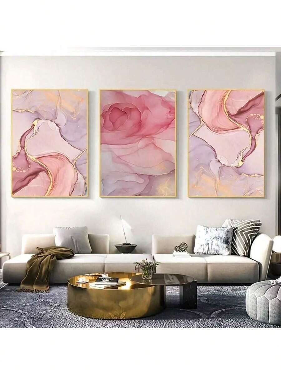 Three pink marble abstract canvas prints with gold accents above beige sofa