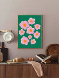 Framed pink and green floral wall art above rustic dining counter