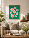 Pink floral poster above cream sofa in sunlit plant-filled living room