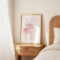 Pink flower canvas shown as framed feminine bedroom art