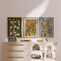 Three pumpkin canvas posters over white sideboard