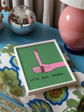White framed It's All Good hand gesture print beside a disco ball and pink lamp