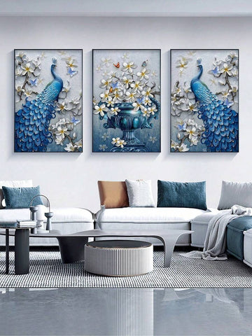 Three framed 3D effect blue peacock and floral vase prints above modern white sofa in living room