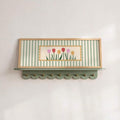 Sage green striped tulip artwork above an entryway shelf