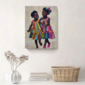 Black girl sisterhood wall art displayed above books and woven basket