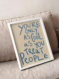 White framed blue quote poster leaning on beige sofa