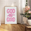 Pink God Is Good quote print leaning in a sunlit floral decor corner