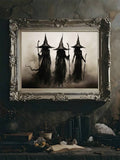 Framed black and beige witch poster beside books and crystals