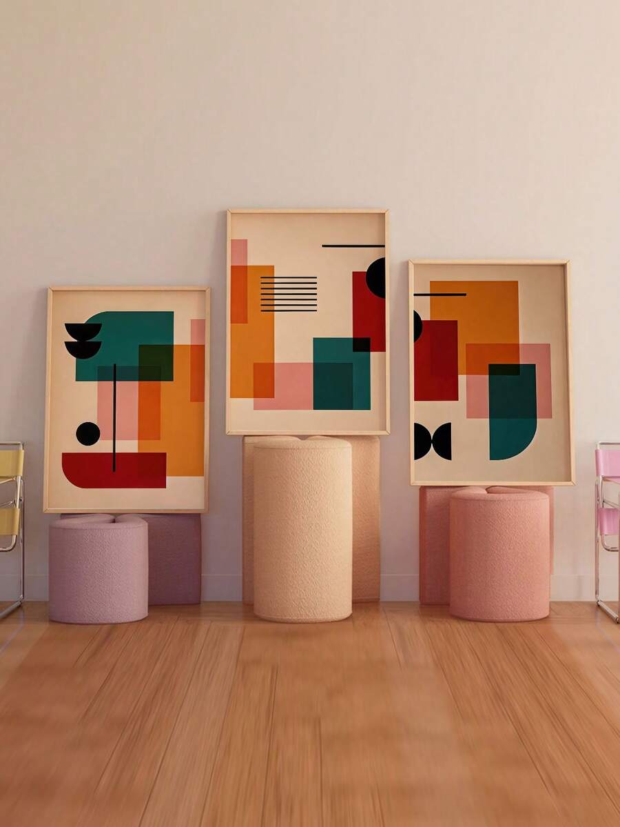Three framed abstract color block prints displayed on pastel cylinder stools