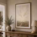 Large path to cross artwork above warm entryway sideboard