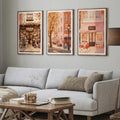 Vintage shop street prints adding color above gray sectional