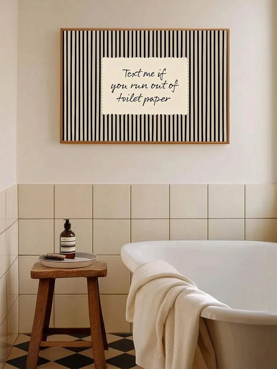 Black striped Text me if you run out of toilet paper poster above bathtub