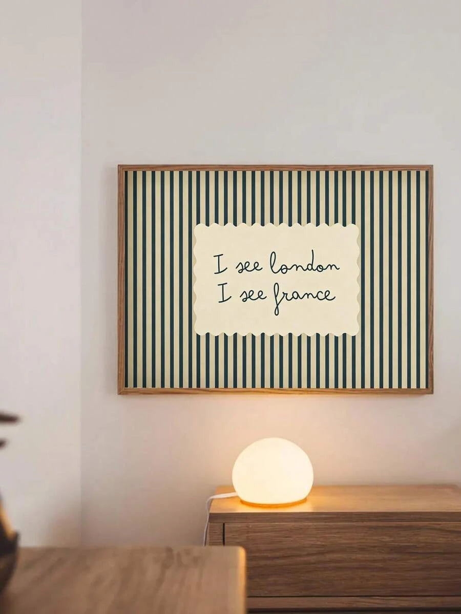 Blue-green striped I see London I see France poster above cabinet and lamp