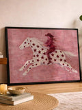 Rider in red feather outfit on white horse with red stars in black-framed artwork