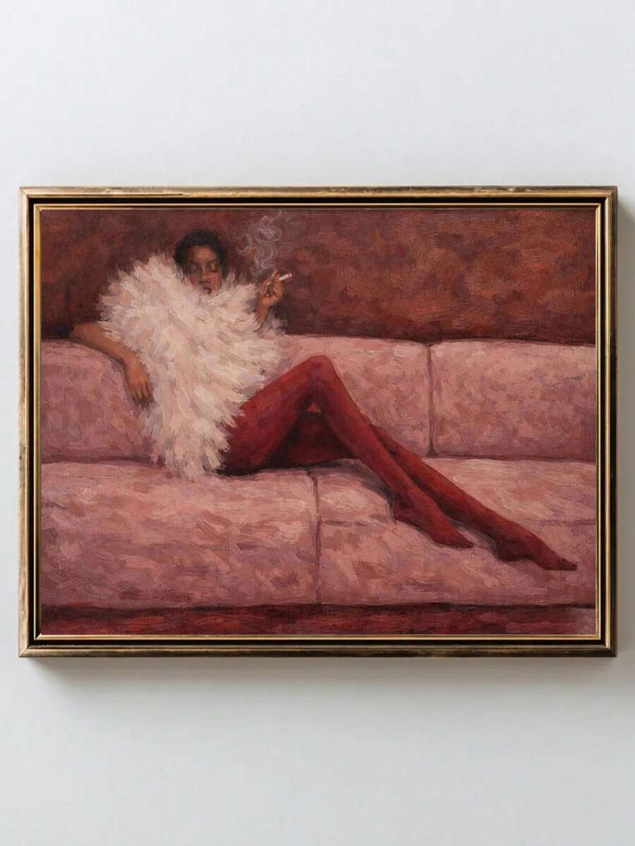Gold-and-black framed reclining woman fashion poster displayed alone on pale wall