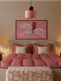 White horse with red stars and fashion rider poster above red-striped bed